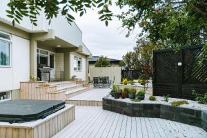 a backyard with a black gate and a house at Smart Luxury - Private Gym, Hot Tub & Sauna in Keflavík