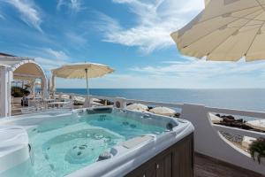 a hot tub on the balcony of a resort with the ocean at Hotel Cavalluccio Marino in Santa Marinella