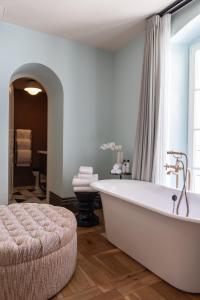 La salle de bains est pourvue d'une baignoire blanche et d'une grande fenêtre. dans l'établissement Soho House Tel Aviv, à Tel Aviv