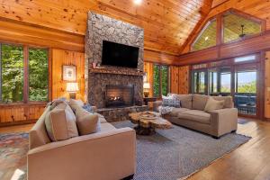 a living room with a fireplace and a tv at Chimney Island in Blowing Rock