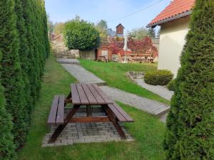 a wooden picnic table in the middle of a garden at Tisá 488 in Tisá