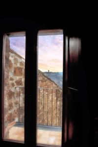 a view from an open window of a building at La Finestra su Civita in Lubriano