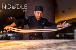 a chef holding a large piece of dough at SAHARA Las Vegas in Las Vegas