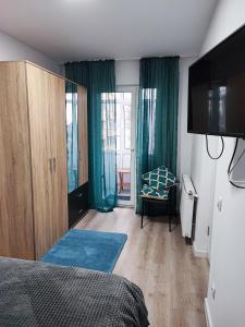 a bedroom with a bed and a sliding glass door at Apartament în Buzău in Buzau