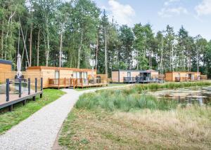 a row of lodges in a park with a river at Woodland Lakes Boutique Lodges 