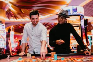 two men are playing roulette in a casino at SAHARA Las Vegas in Las Vegas