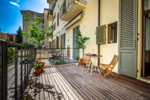 a wooden deck with a table and chairs on a balcony at Luxury apt in the heart of city out of ZTL in Florence
