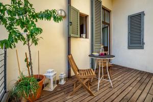 a patio with a table and chairs on a deck at Luxury apt in the heart of city out of ZTL in Florence