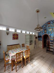 a dining room with a table and chairs and a fireplace at Casa Muse in Maiori
