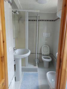 a bathroom with a sink and a toilet at Casa Muse in Maiori +29 photos