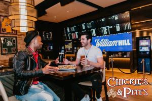 two men sitting at a table in a bar at SAHARA Las Vegas in Las Vegas