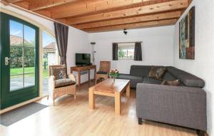 a living room with a couch and a table at Beautiful Home In Ijhorst With House A Panoramic View in IJhorst