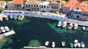 a group of boats are docked in a harbor at Sunshine Villa in Stoupa