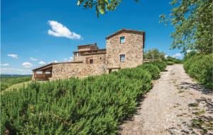 an old stone building on a hill with a dirt road at Santantimo in Castellina in Chianti