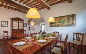 a dining room with a large wooden table and chairs at Santantimo in Castellina in Chianti