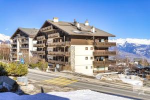 a large apartment building on the side of a road at Appartement Rosalp, 200m des télécabines, in Nendaz