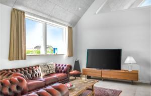 a living room with a couch and a flat screen tv at Lovely Home In Ringkøbing With Sauna in Ringkøbing
