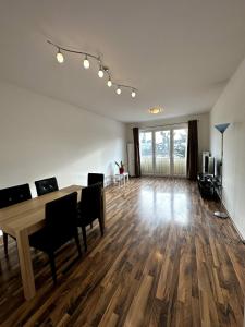 an empty living room with a wooden table and chairs at Willy Studio Apartment Frankfurt in Frankfurt/Main