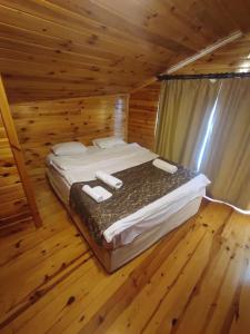 a bedroom with a bed in a log cabin at Ağva Serenita Villa in Sile