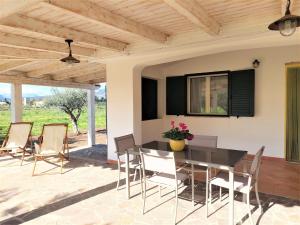 a dining room with a table and chairs on a patio at Appartamenti Sisula Manna in Orosei +45 photos