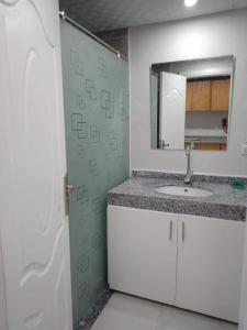 a bathroom with a sink and a mirror at The Comfortable palace in Hurghada