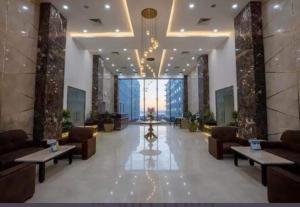 a lobby with couches and tables in a building at The Comfortable palace in Hurghada