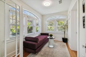 a living room with a couch and windows at Lake apt 5 minutes to downtown in St Petersburg