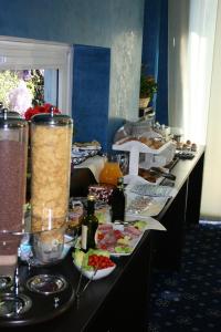 
a table topped with bowls of food and drinks at Hotel Fiera Congressi in Milan
