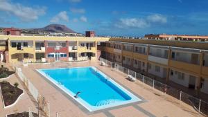 a large swimming pool in front of a building at Casa Bea in La Oliva