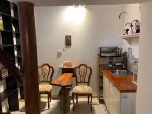 a kitchen with two chairs and a table and a sink at Sweet ‘En Kerem View in Jerusalem