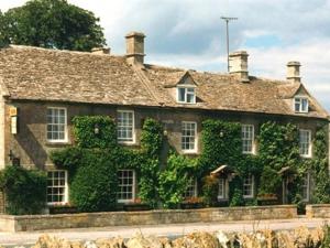 a building covered in ivy with at Inn for All Seasons in Burford