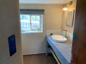 a bathroom with a sink and a window at Sweet ‘En Kerem View in Jerusalem