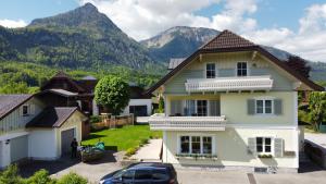a house with mountains in the background at Apartment Brigitte Schöndorfer in Strobl