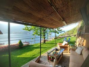 a living room with a view of the water at Mella house garden relax in Lezzeno