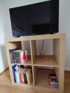 a wooden tv stand with a flat screen television on top at SUNNY SIDE in Kiel