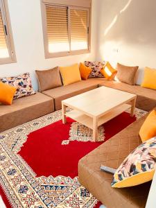 a living room with a couch and a coffee table at Dakhla sky blue in Dakhla
