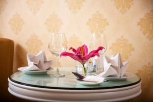 a table with two wine glasses and paper napkins at Skyline Hanoi Hotel in Hanoi