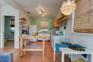 a kitchen with a table and a counter top at Spanish Bungalow Guest House in Daytona Beach +5 photos