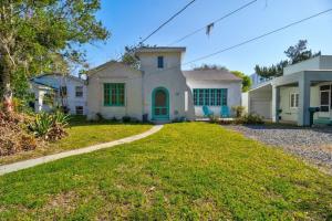 a large white house with a grass yard at Spanish Beach Bungalow MainHouse in Daytona Beach