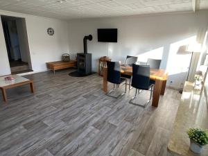 a living room with a table and chairs and a television at Entspannung im Grünen in Horn-Bad Meinberg