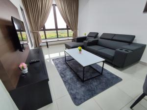 a living room with a couch and a table at Bali Residence Melaka by Jzstay 2BR in Melaka