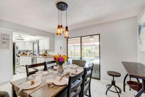 a kitchen and dining room with a table and chairs at Punta Gorda Canal Home with Private Pool! in Punta Gorda