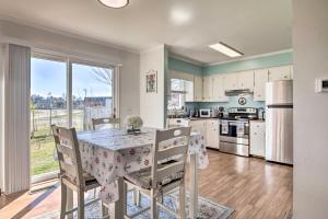 a kitchen with a table and chairs and a large window at Milton Townhouse about 9 Mi to Delaware Bay! in Milton