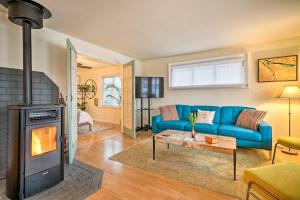 a living room with a blue couch and a fireplace at Portland Floating Home Getaway with Sauna! in Portland