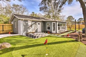 a house with a yard with a putting green at Emerald Coast Vacation Rental 1 Mi to Beach in Shalimar