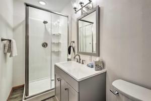 a bathroom with a sink and a shower with a mirror at Missouri Retreat about 7 Mi to Silver Dollar City in Branson West +18 photos