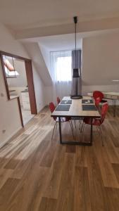 a dining room with a table and red chairs at FewoFaubelCentro 42 & 54 & 62 m2 in Oberhausen