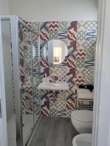 a bathroom with a sink and a mirror at Casa al Mare in Bari