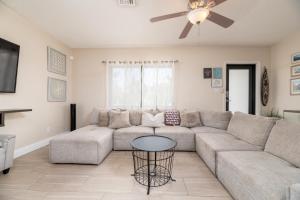 a living room with a couch and a ceiling fan at Home at Poinsettia Heights in Fort Lauderdale