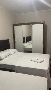 Łóżko lub łóżka w pokoju w obiekcie Apart-Hotel Ijuí
